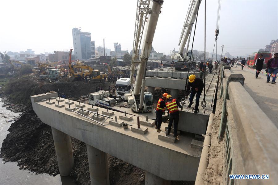 Engineers check the placement of concrete beams at the construction site of ongoing Ring Road expansion project assisted by China at Koteshwor, Kathmandu, Nepal, Jan. 14, 2016. 