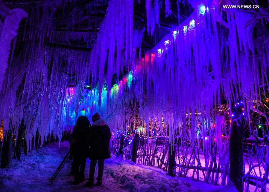 Tourists sightsee in Snow Village resort near Laobai Mountain in Dunhua, northeast China's Jilin Province, Jan. 14, 2016. 