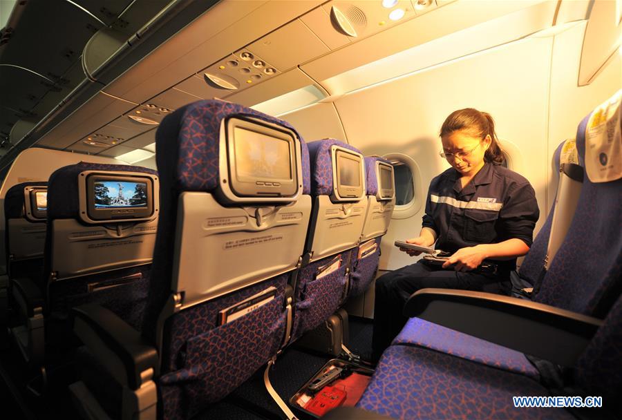 A staff member checks cabin seats at the maintenance base of China Southern Airlines in Haikou, capital of south China's Hainan Province, on Jan. 21, 2016. 