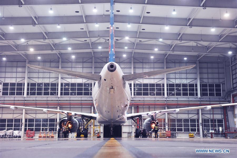 Mechanics check aircraft engines at the maintenance base of China Southern Airlines in Haikou, capital of south China's Hainan Province, on Jan. 21, 2016. 