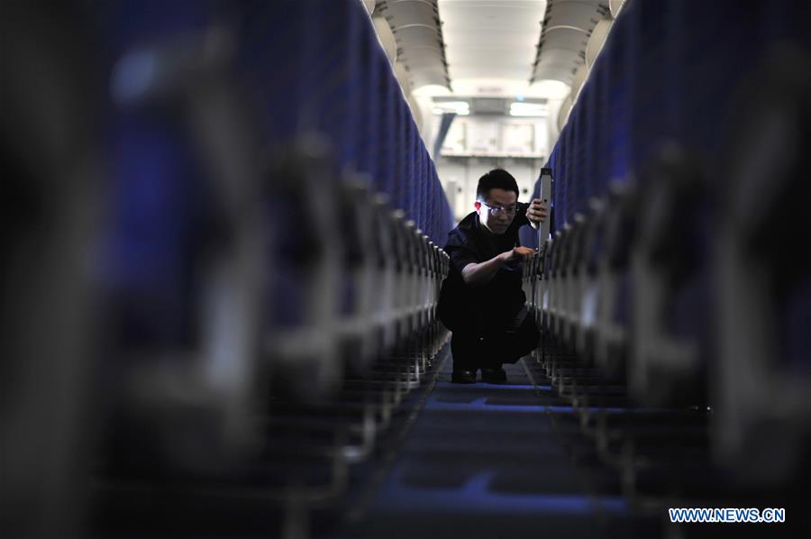 A staff member checks cabin seats at the maintenance base of China Southern Airlines in Haikou, capital of south China's Hainan Province, on Jan. 21, 2016. 