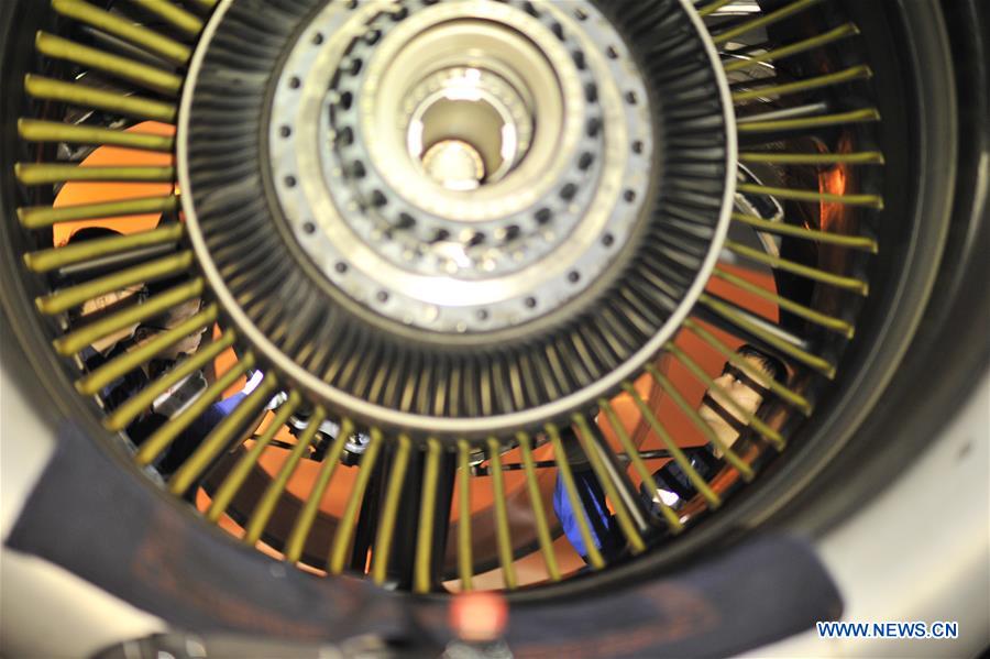 Mechanics check an aircraft engine at the maintenance base of China Southern Airlines in Haikou, capital of south China's Hainan Province, on Jan. 21, 2016. 