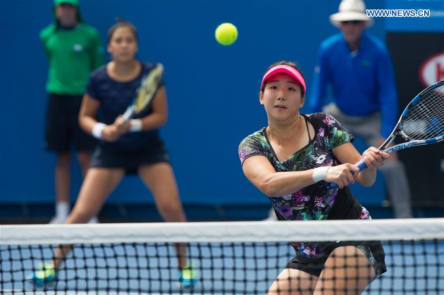 Zhang Kailin (Front) of China and Zarina Diyas of Kazakhstan compete during the first round match of women's doubles against Margarita Gasparyan and Alexandra Panova of Russia at the Australian Open Tennis Championships at Melbourne Park in Melbourne, Australia, Jan. 21, 2016. 