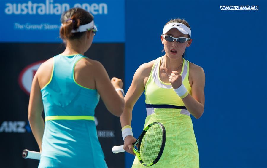 Zheng Saisai (R) and Xu Yifan of China react during the first round match of women's doubles against Jelena Ostapenko of Latvia and Yulia Putintseva of Kazakhstan at the Australian Open Tennis Championships at Melbourne Park in Melbourne, Australia, Jan. 21, 2016. 