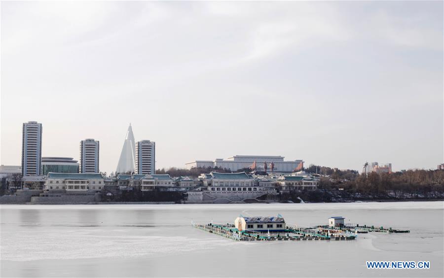 Citizens ice fish on the frozen Taedong River in Pyongyang, capital of the Democratic People's Republic of Korea (DPRK), on Jan. 22, 2016. 