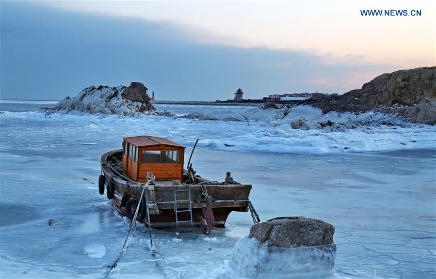 A boat is trapped by sea ice in Qinhuangdao, north China's Hebei Province, Jan. 23, 2016. 