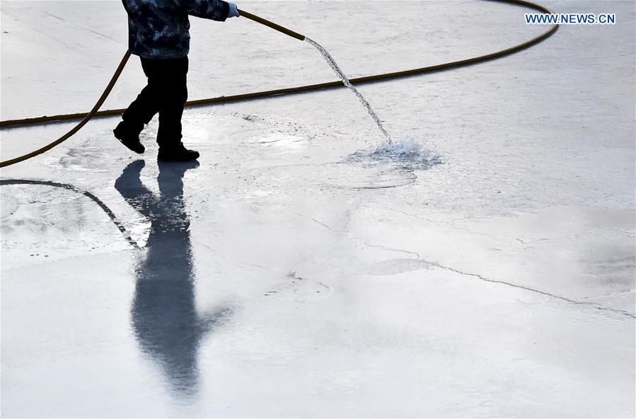 A worker works on a skating rink in Longtan Park of Beijing, capital of China, Jan. 18, 2016.