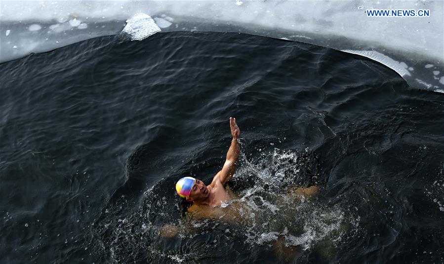 A man swims in the Haihe River in Tianjin, north China, Jan. 22, 2016. 