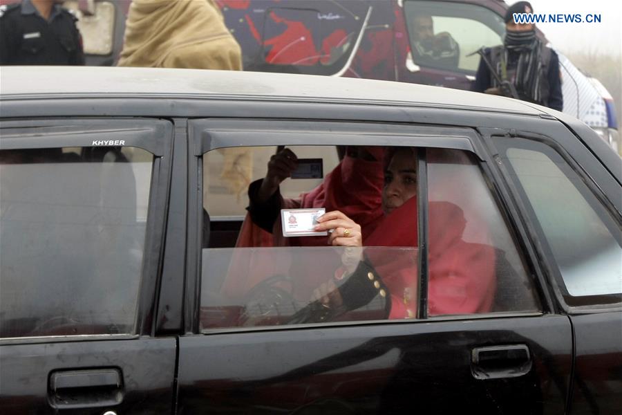 Pakistani students show their ID cards as they arrive at the Bacha Khan University in Charsadda, northwest Pakistan, Jan. 25, 2016. 