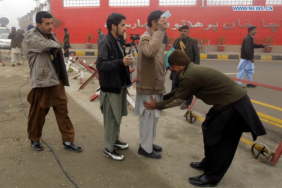 A Pakistani policeman checks students outside the Bacha Khan University in Charsadda, northwest Pakistan, Jan. 25, 2016.