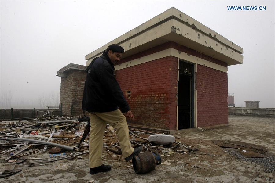 A Pakistani policeman inspects the attack site at the Bacha Khan University in Charsadda, northwest Pakistan, Jan. 25, 2016.