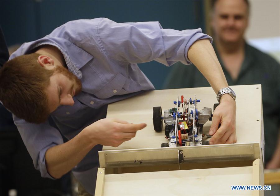 A student adjusts his robotic vehicle during a competition at the University of British Columbia in Vancouver, Cananda, Jan. 27, 2016. 