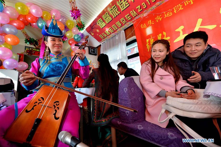 Actors perform on the train Z316, a train heading from Hohhot, capital of north China's Inner Mongolia Autonomous Region, to Beijing, capital of China, to celebrate the Xiaonian Festival, Feb. 1, 2016. 