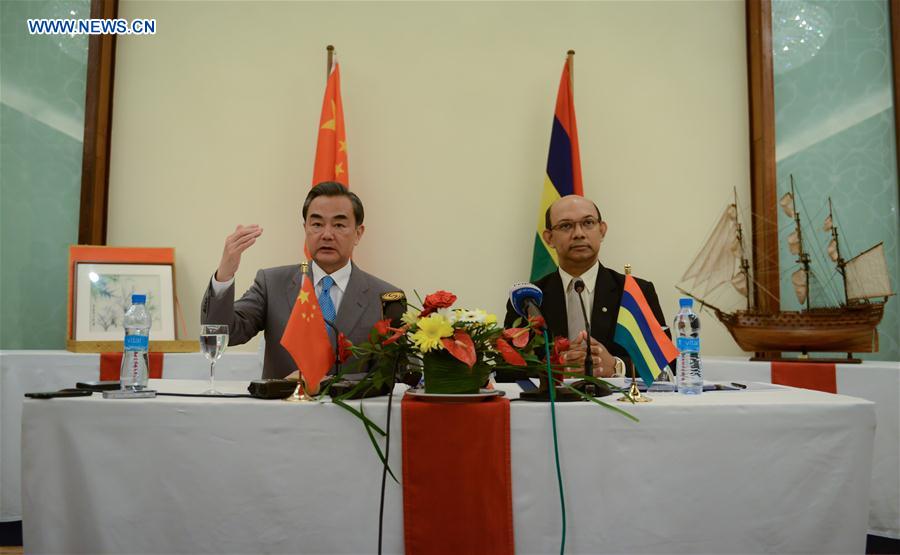 Visiting Chinese Foreign Minister Wang Yi (L) and Etienne Sinatambou, Minister of Foreign Affairs, Regional Integration and International Trade of Mauritius, hold a press conference after their meeting, in Flic en Flac, Mauritius, on Feb. 1, 2016.