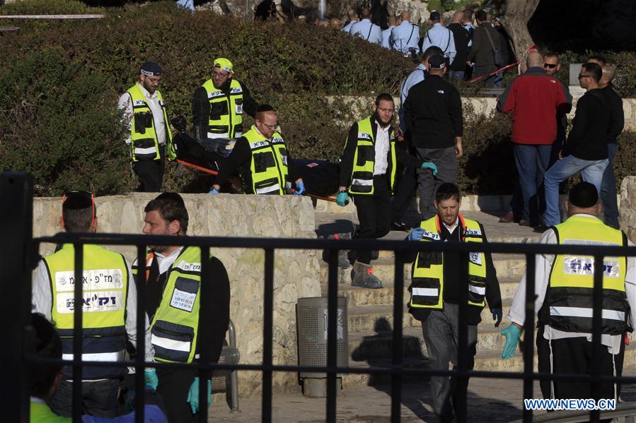 Israeli police officers inspect the bodies of the reported Palestinian assailants who were killed following an attack at Damascus Gate, a main entrance to Jerusalem's Old City, Feb. 3, 2016.