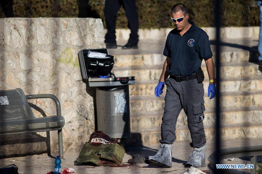 Israeli police officers inspect the bodies of the reported Palestinian assailants who were killed following an attack at Damascus Gate, a main entrance to Jerusalem's Old City, Feb. 3, 2016.