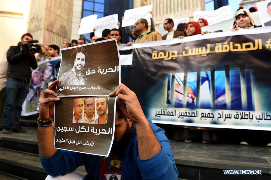 Protesters hold posters during a protest demanding the release of journalists arrested by police in front of the Syndicate of Journalists in Cairo, Egypt on Feb. 11, 2016. 