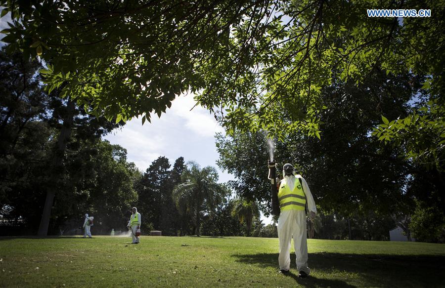 Argentina's Environment and Public Space Ministry fumigation brigade members spay insecticide in an area of Saavedra Park, in an effort to control the Aedes aegypti mosquito, in Buenos Aires, capital of Argentina, on Feb. 11, 2016. 