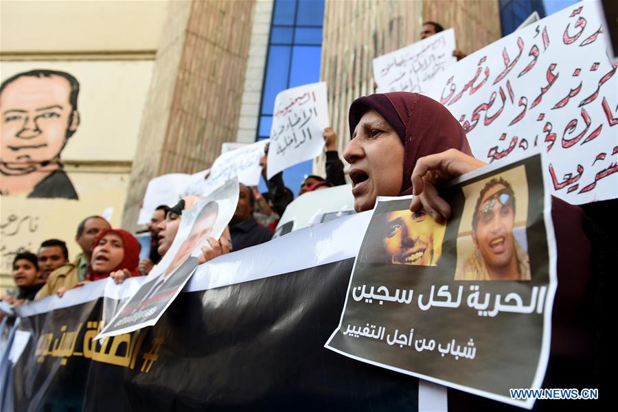 Protesters hold posters during a protest demanding the release of journalists arrested by police in front of the Syndicate of Journalists in Cairo, Egypt on Feb. 11, 2016. 