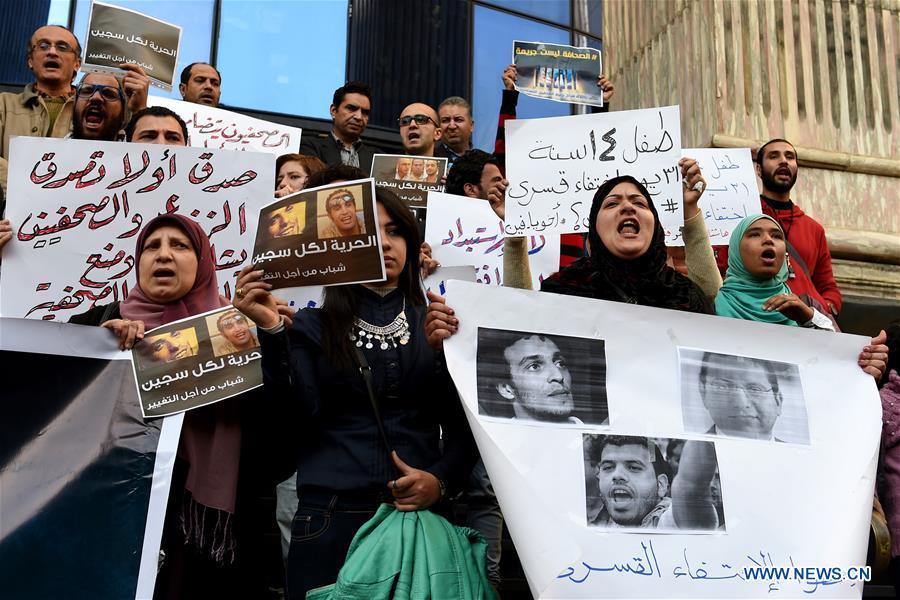 Protesters hold posters during a protest demanding the release of journalists arrested by police in front of the Syndicate of Journalists in Cairo, Egypt on Feb. 11, 2016. 