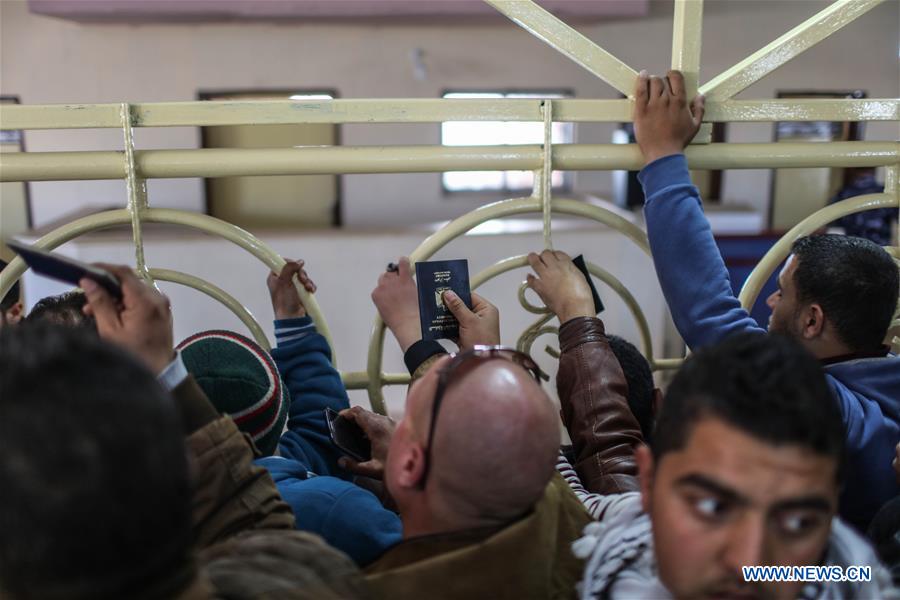 Palestinians wait for travel permit to cross into Egypt at the Rafah border crossing between Egypt and the southern Gaza Strip on Feb. 13, 2016. 