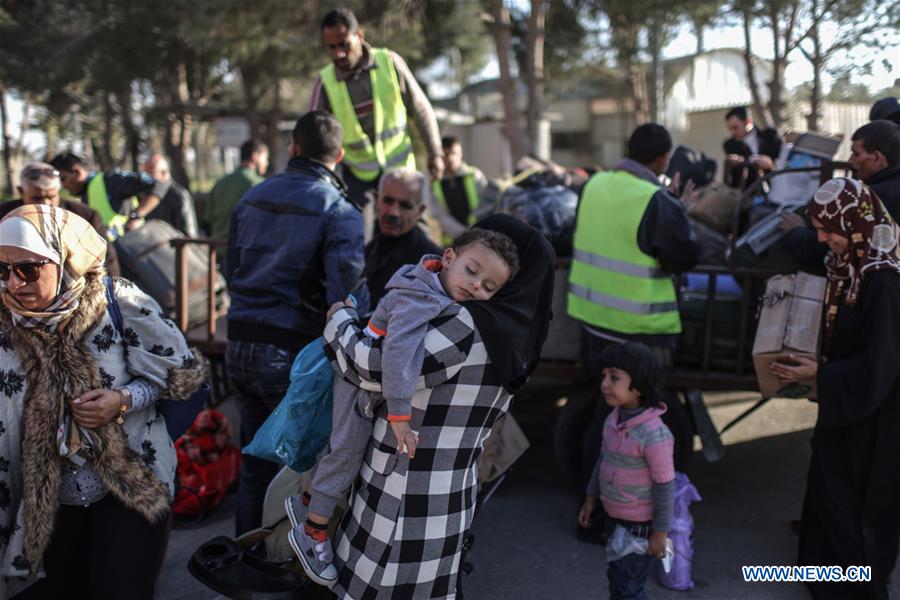 Palestinians wait for travel permit to cross into Egypt at the Rafah border crossing between Egypt and the southern Gaza Strip on Feb. 13, 2016. 