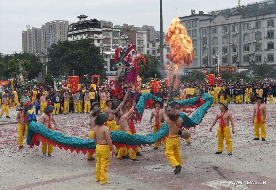 The Binyang-style dance is a derivative of traditional dragon dance in which performers hold dragon on poles and walk through floods of firecrackers.