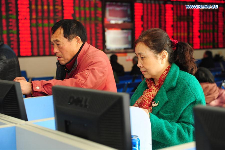 Investors watch stock movements in a securities company in Fuyang, east China's Anhui Province, Feb. 17, 2016. 