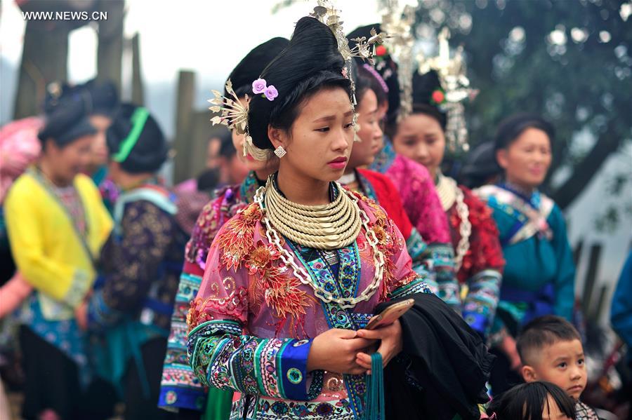 Women of Miao ethnic group attend a festival gathering to sing Miao songs at Ma'an Village of Congjiang County, Qiandongnan Miao and Dong Autonomous Prefecture, southwest China's Guizhou Province, Feb. 13, 2016. 