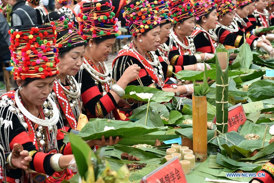 More than 3,000 people gathered here to share the feast, which is featured with leaf-made bowls, bamboo-tube wine glasses and potherb meals.