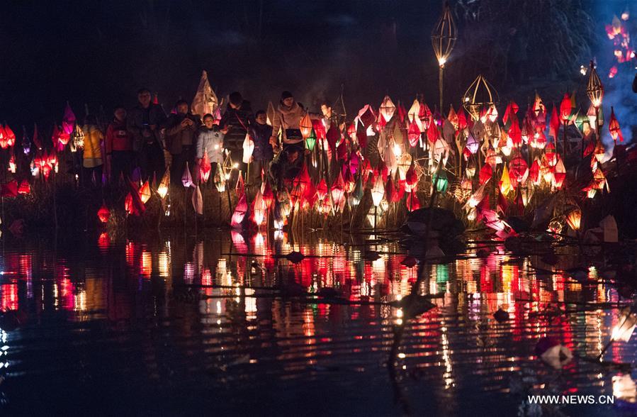 Local residents hold a lantern parade to celebrate the Toad Festival, a tradition to wish for good health and harvest in the lunar new year when people send away a symbolic toad figure representing illness, in Nanchong, southwest China's Sichuan Province, Feb. 21, 2016.