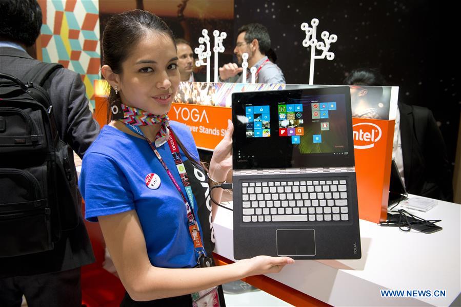 A model holds the new device YOGA 710 of Chinese company Lenovo just released at the Mobile World Congress in Barcelona, Spain, Feb. 23, 2016. 