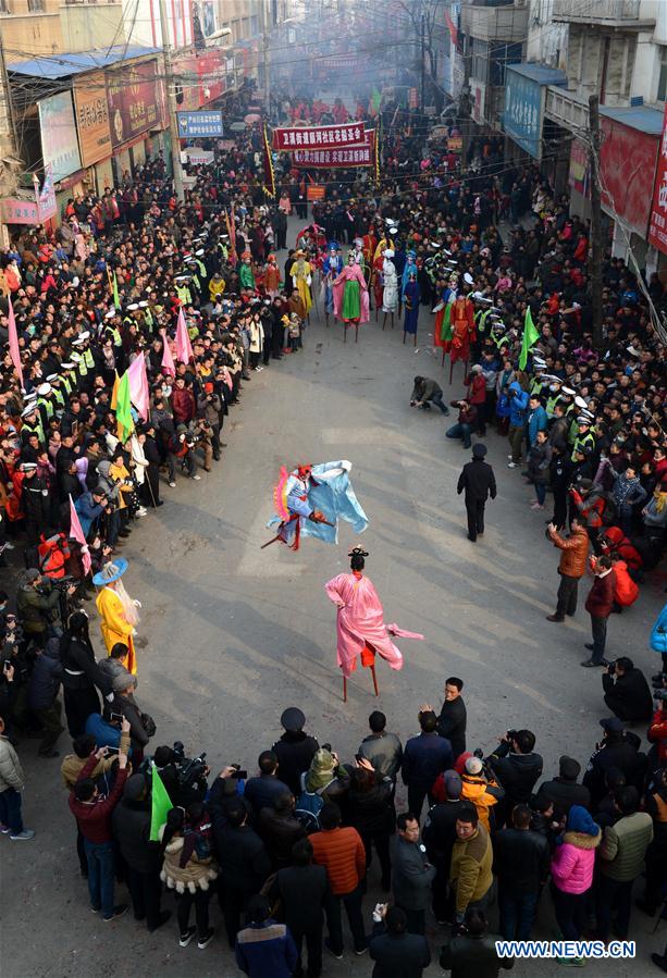 Rural folk performers dressed in traditional costume takes part in a parade to celebrate the Chinese lunar New Year at a temple fair in Xunxian County of Hebi City, central China's Henan Province, Feb. 23, 2016.