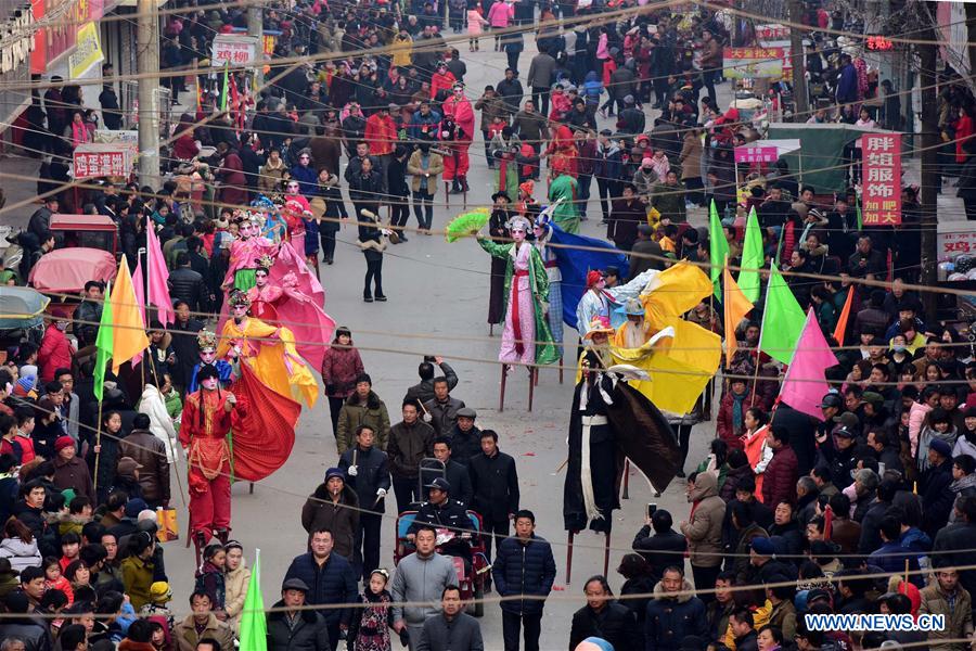 Rural folk performers dressed in traditional costume takes part in a parade to celebrate the Chinese lunar New Year at a temple fair in Xunxian County of Hebi City, central China's Henan Province, Feb. 23, 2016. 