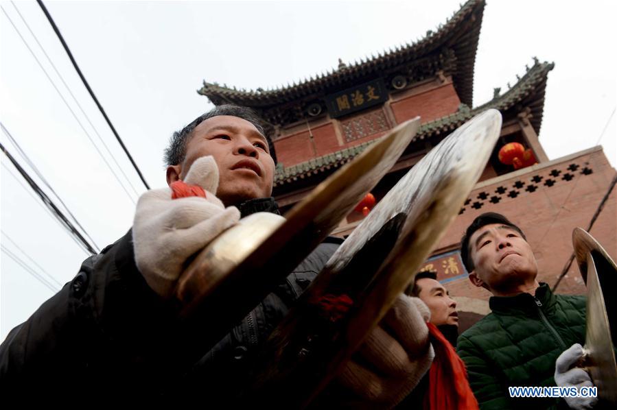 Rural folk performers takes part in a parade to celebrate the Chinese lunar New Year at a temple fair in Xunxian County of Hebi City, central China's Henan Province, Feb. 23, 2016. 