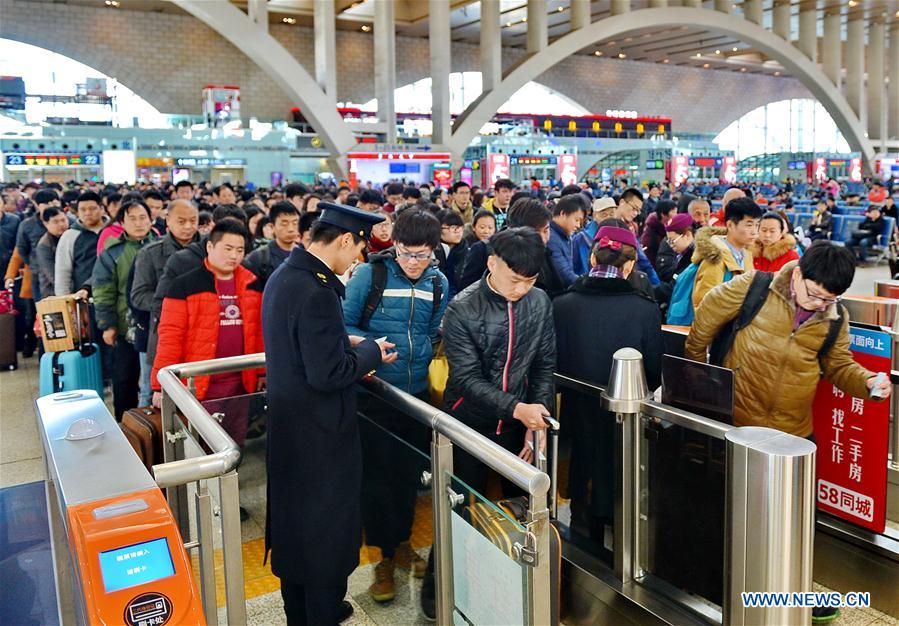 Passengers have tickets checked and get into the railway station in Shijiazhuang, capital of north China's Hebei Province, Feb. 24, 2016.