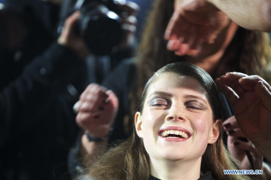  A model has her hair styled at backstage before the Anteprima show during Milan Fashion Week Fall/Winter 2016/17 in Milan, Italy, Feb. 25, 2016. 