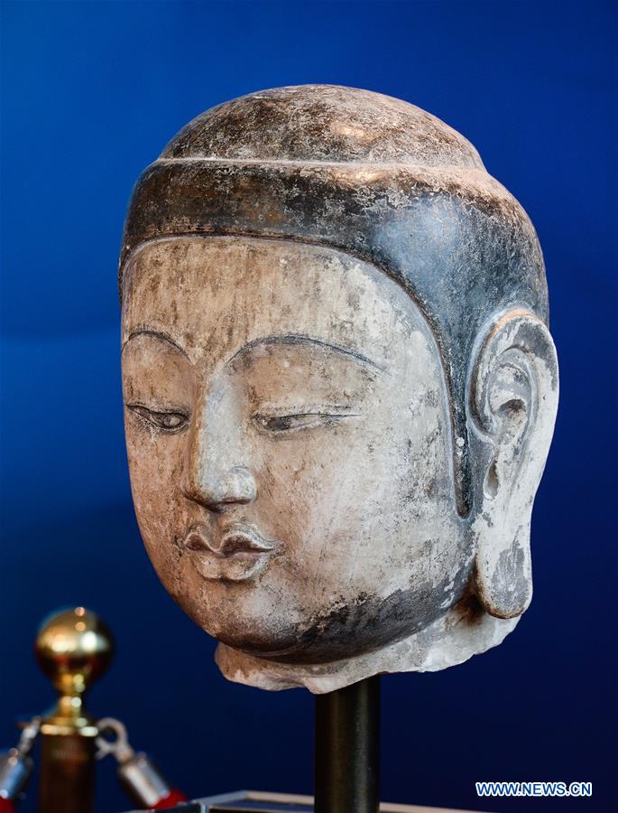 Photo taken on Feb. 26, 2016 shows the returning head of an ancient Buddhist sculpture of the North Qi (550-557) period in Beijing, capital of China. 