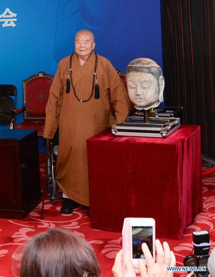 Master Hsing Yun attends a press conference on the returning of the head of an ancient Buddhist sculpture of the North Qi (550-557) period in Beijing, capital of China, Feb. 26, 2016.