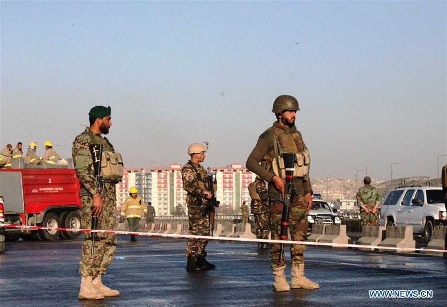 An Afghan security force member stands guard at the site of a suicide attack in Kunar province, eastern Afghanistan, Feb. 27, 2016. 