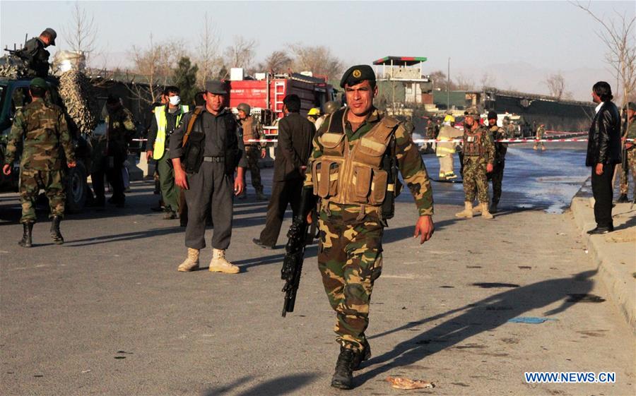 An Afghan security force member stands guard at the site of a suicide attack in Kunar province, eastern Afghanistan, Feb. 27, 2016. 