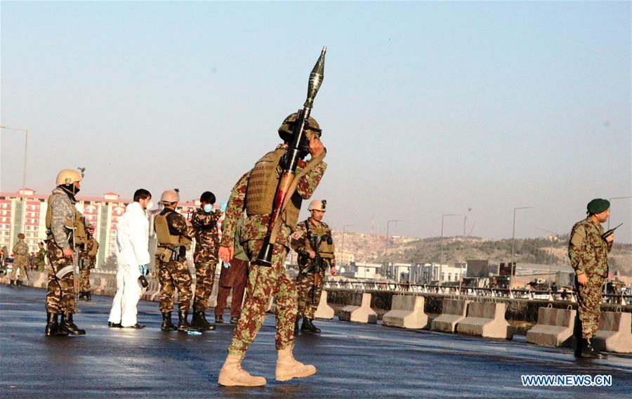 An Afghan security force member stands guard at the site of a suicide attack in Kunar province, eastern Afghanistan, Feb. 27, 2016. 