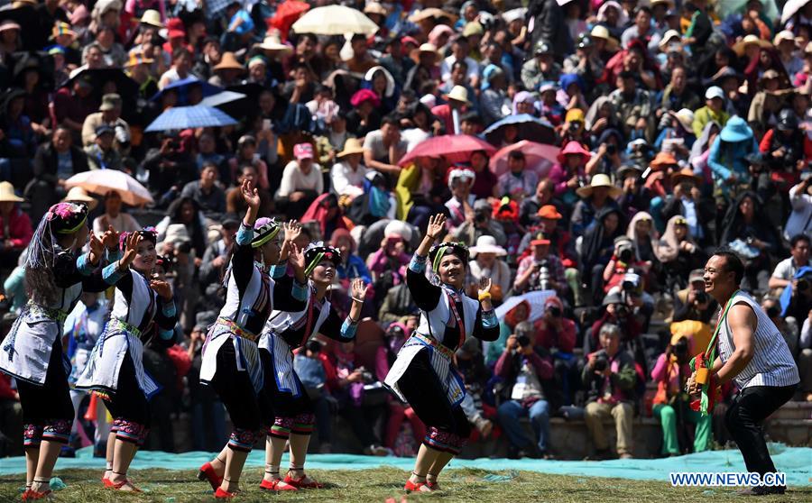 People of Yi ethnic group perform 'Axi Dance in the Bright Moonlight,' during the annual fire worshipping festival, which falls on the third day of the second month in the Chinese lunar calendar, in Hongwan Village of Xiyi Township in Mile City, southwest China's Yunnan Province, March 11, 2016. 