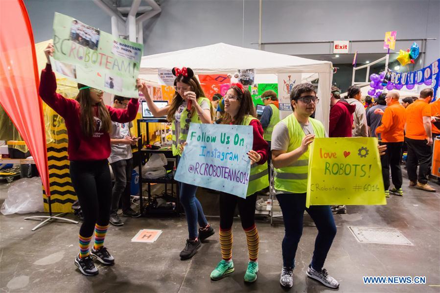 Team members of 'FLYBOTS' from Brooklyn's Paul Robeson High School work on their robot at the 2016 FIRST Robotics Competition New York Regional in Jacob Javits Convention Center in New York City, the United States, March 11, 2016.