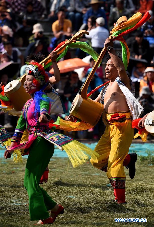 People of Yi ethnic group perform 'Axi Dance in the Bright Moonlight,' during the annual fire worshipping festival, which falls on the third day of the second month in the Chinese lunar calendar, in Hongwan Village of Xiyi Township in Mile City, southwest China's Yunnan Province, March 11, 2016. 