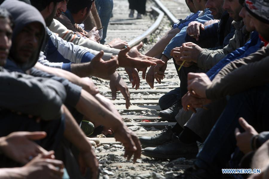 Refugees rest during a protest in Eidomeni claiming for the opening of the border crossing between Greece and the Former Yugoslav Republic of Macedonia (FYROM) on March 21, 2016.