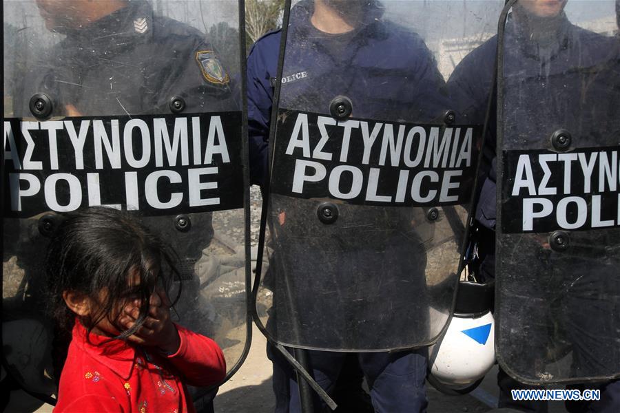 Refugees rest during a protest in Eidomeni claiming for the opening of the border crossing between Greece and the Former Yugoslav Republic of Macedonia (FYROM) on March 21, 2016.