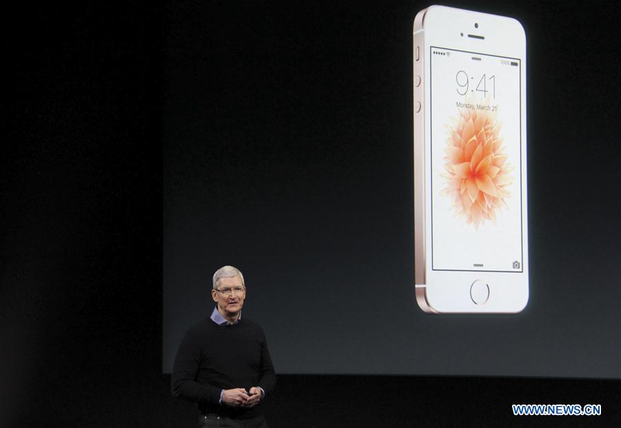 Visitors take photos of the new iPhones, named iPhone SE, during an event to announce new products at Apple's headquarters in Cupertino, California, the United States, March 21, 2016. 