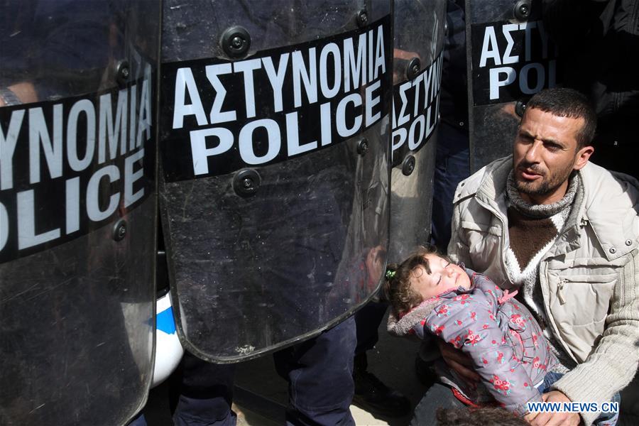 Refugees rest during a protest in Eidomeni claiming for the opening of the border crossing between Greece and the Former Yugoslav Republic of Macedonia (FYROM) on March 21, 2016.