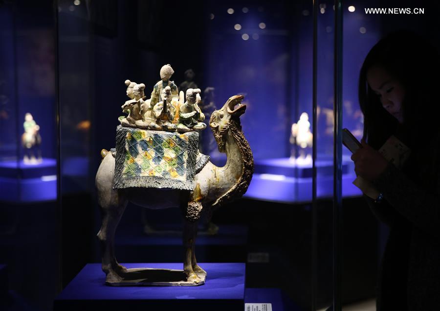 A tri-colored glazed pottery work showing a camel figure is seen displayed at an exhibition in Shaanxi History Museum in Xi'an, capital of northwest China's Shaanxi Province, March 23, 2016. 